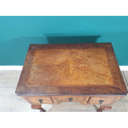 630 - A 19th Century walnut Lowboy with quarter veneered and crossbanded top, fitted three drawers around ... 