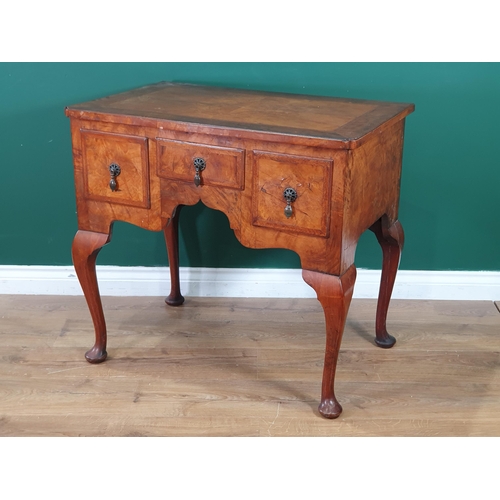 630 - A 19th Century walnut Lowboy with quarter veneered and crossbanded top, fitted three drawers around ... 