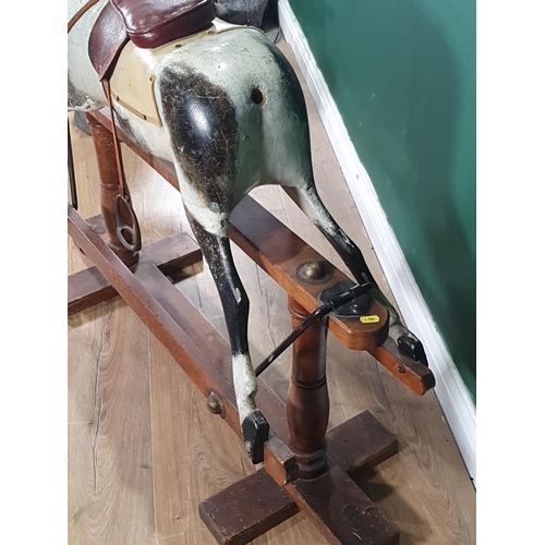 643 - A painted and carved wooden Rocking Horse by Lines Bros for Triang with mane (lacks tail), saddle an... 