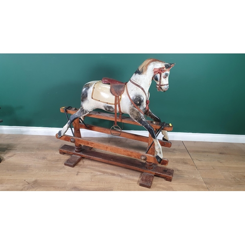 643 - A painted and carved wooden Rocking Horse by Lines Bros for Triang with mane (lacks tail), saddle an... 