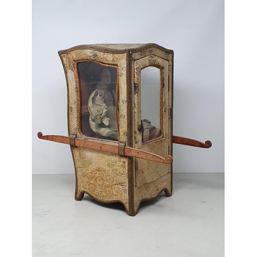 646 - An antique Doll's Sedan Chair with fabric covering and glazed door 14in H x 7in W, with an antique f... 