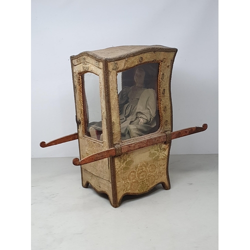 646 - An antique Doll's Sedan Chair with fabric covering and glazed door 14in H x 7in W, with an antique f... 