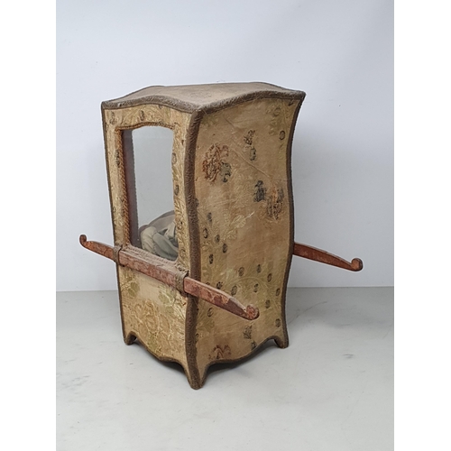 646 - An antique Doll's Sedan Chair with fabric covering and glazed door 14in H x 7in W, with an antique f... 