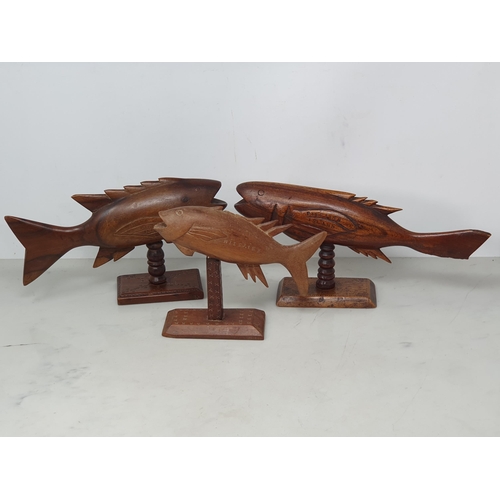 651 - Three carved wooden Fish on stands impressed 'Pitcairn Island (one has broken lower tail fin), anoth... 