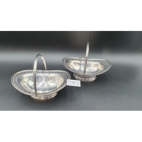 7 - A pair of Victorian silver pierced oval Sweetmeat Baskets with swing handles on pedestal bases, Shef... 