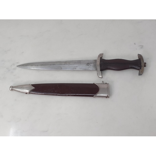 749 - A WWII SA Dagger in brown scabbard with wooden grip lacking emblem, blade engraved 'RZM M7/85'