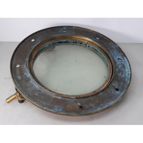 767 - An antique brass Ship's Porthole, 16in D