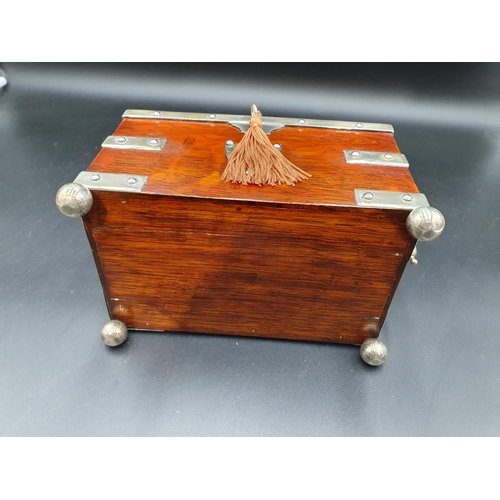 78 - A Victorian plated mounted oak Tea Caddy with scroll engraved lid enclosing two lidded divisions, or... 