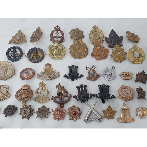 793 - A large collection of Colonial and British Army Cap and other Badges