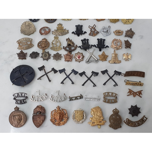 793 - A large collection of Colonial and British Army Cap and other Badges