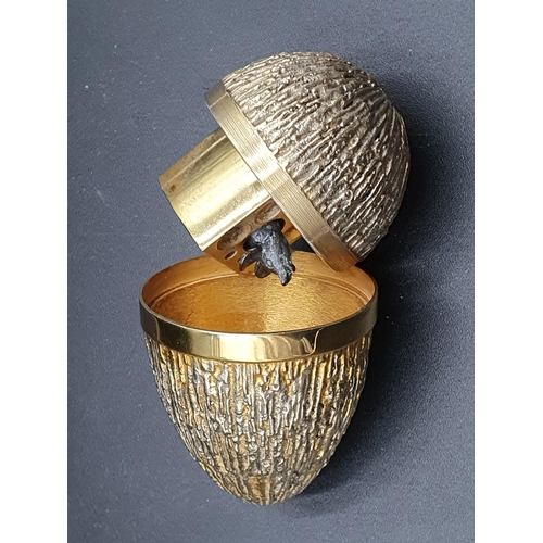 86 - A Stuart Devlin silver-gilt limited edition Egg with bark effect textured finish enclosing a mouse a... 