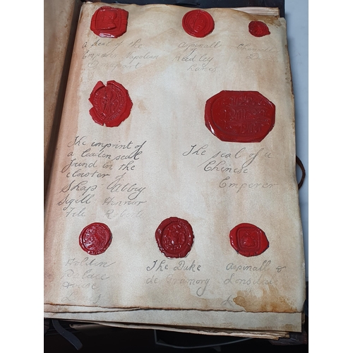 873 - A leather bound Book of historical seals, and a list of the names of the families