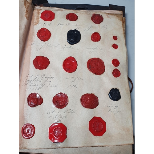 873 - A leather bound Book of historical seals, and a list of the names of the families