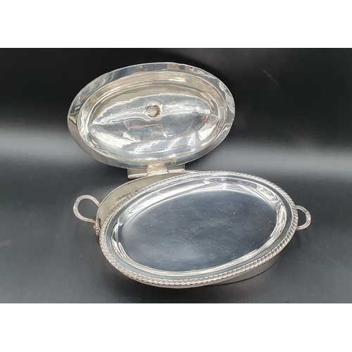 9 - A Georgian Sheffield plated oval two handled Entree Dish and Cover with gadroon rim and flower finia... 