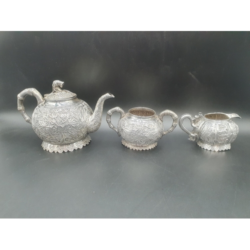 90 - A Chinese silver three piece Tea Service of globular form, the teapot and sugar bowl with all over b... 