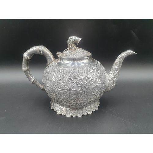 90 - A Chinese silver three piece Tea Service of globular form, the teapot and sugar bowl with all over b... 