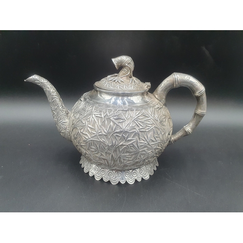 90 - A Chinese silver three piece Tea Service of globular form, the teapot and sugar bowl with all over b... 