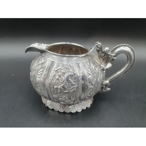 90 - A Chinese silver three piece Tea Service of globular form, the teapot and sugar bowl with all over b... 