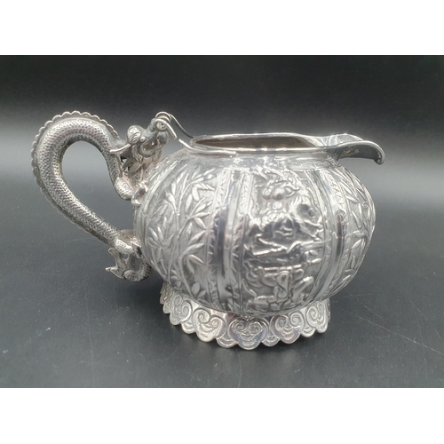 90 - A Chinese silver three piece Tea Service of globular form, the teapot and sugar bowl with all over b... 