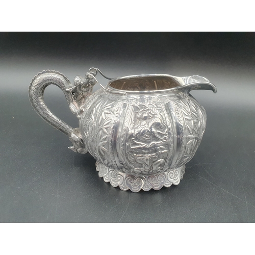 90 - A Chinese silver three piece Tea Service of globular form, the teapot and sugar bowl with all over b... 