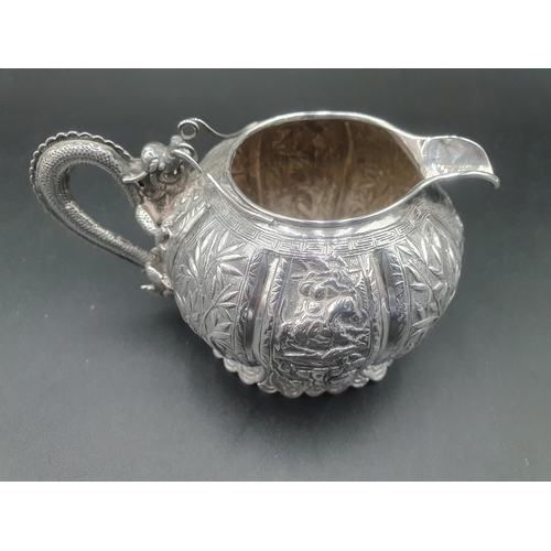 90 - A Chinese silver three piece Tea Service of globular form, the teapot and sugar bowl with all over b... 