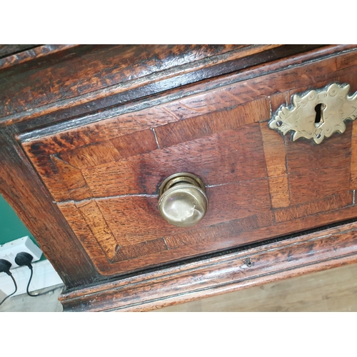 528 - An 18th Century oak Dresser Base with raised back, fitted four crossbanded frieze drawers on turned ... 