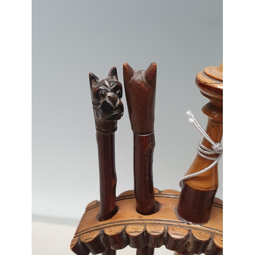 563 - A set of antique treen Tools with bulldog head handles within turned wooden Stand 8 1/2in H