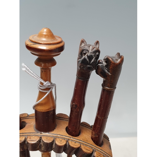 563 - A set of antique treen Tools with bulldog head handles within turned wooden Stand 8 1/2in H