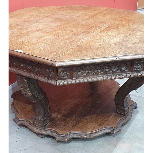 631 - A Victorian Continental oak octagonal Centre Table with moulded edge, with carved frieze, raised on ... 