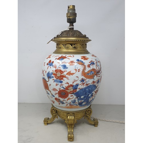 404 - A Chinese porcelain and gilt metal Table Lamp with design of dragons and flowers and raised on four ... 