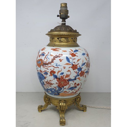 404 - A Chinese porcelain and gilt metal Table Lamp with design of dragons and flowers and raised on four ... 