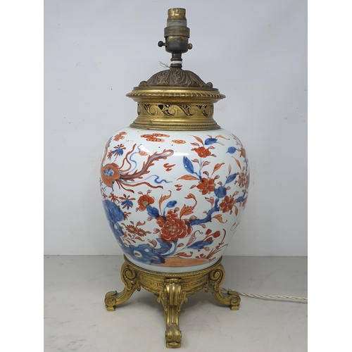 404 - A Chinese porcelain and gilt metal Table Lamp with design of dragons and flowers and raised on four ... 