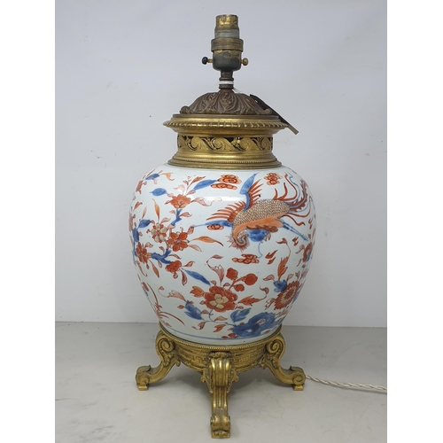 404 - A Chinese porcelain and gilt metal Table Lamp with design of dragons and flowers and raised on four ... 