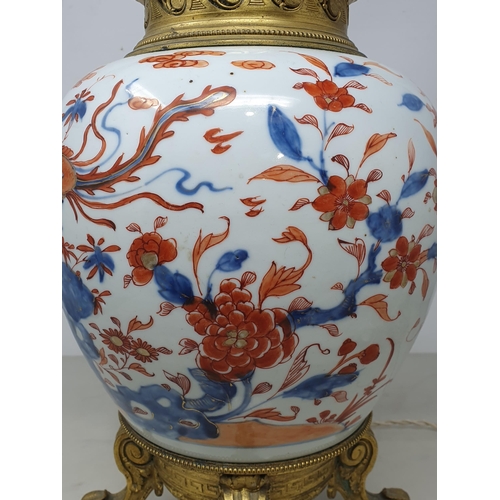 404 - A Chinese porcelain and gilt metal Table Lamp with design of dragons and flowers and raised on four ... 