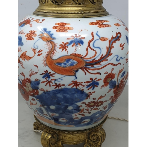 404 - A Chinese porcelain and gilt metal Table Lamp with design of dragons and flowers and raised on four ... 