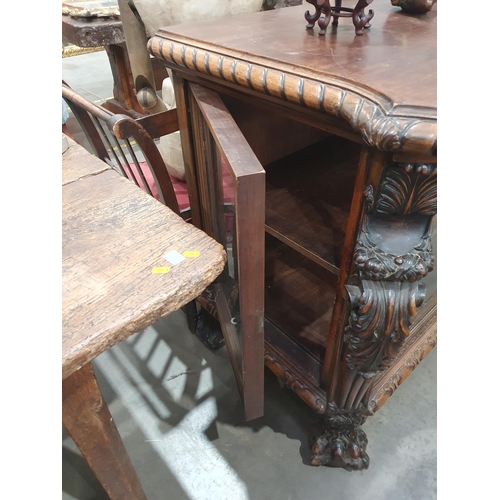 538 - A carved walnut Display Cabinet with bevelled glazed front panel flanked by acanthus leaf pillars wi... 