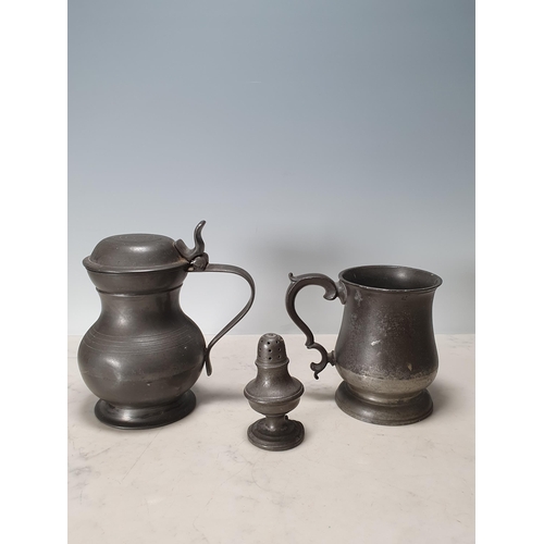 417 - A pewter lidded Baluster Tankard with a shaped thumb rest and handle, marked London, 7 in High, anot... 