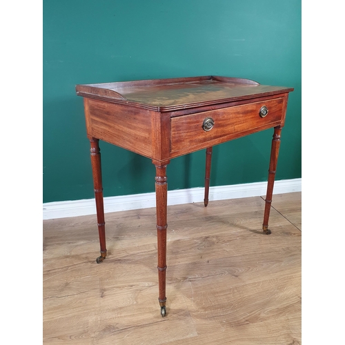 603 - A Regency mahogany Sidetable, the galleried moulded top above a frieze drawer, on slender ring turne... 