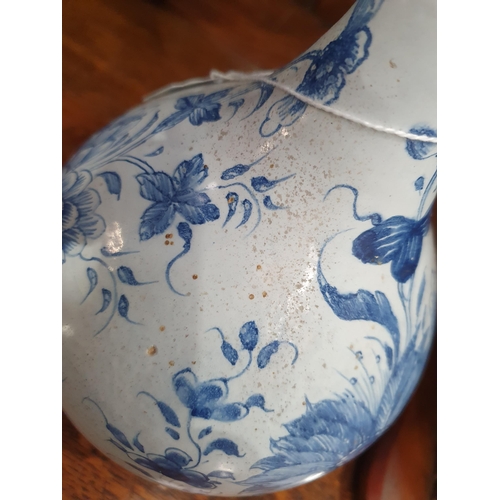 394 - A blue and white Delft Bottle Shaped Vase with all over Floral designs (Rim Chipped) 9.5