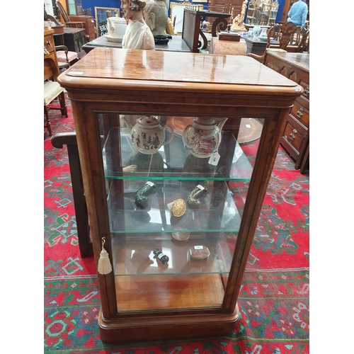 525 - A good quality late Victorian burr walnut Display Cabinet with moulded top above a single glazed doo... 