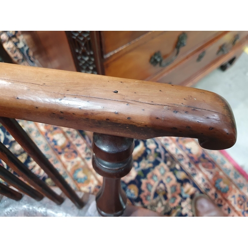 541 - A 19th Century large yew Windsor Elbow Chair with pierced splat back & crinoline stretcher.