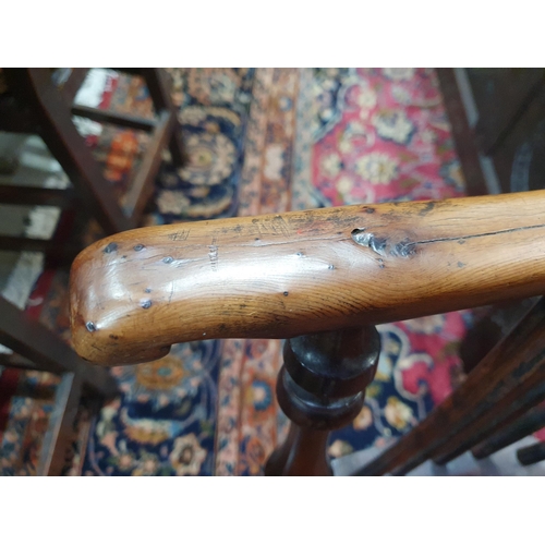 541 - A 19th Century large yew Windsor Elbow Chair with pierced splat back & crinoline stretcher.