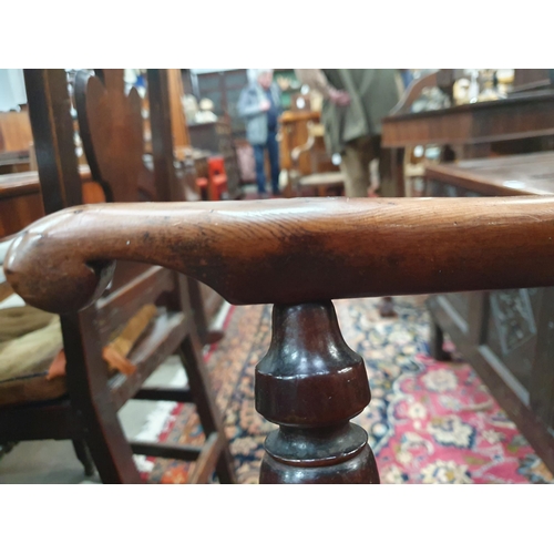 541 - A 19th Century large yew Windsor Elbow Chair with pierced splat back & crinoline stretcher.