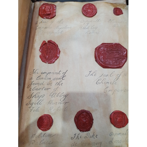 873 - A leather bound Book of historical seals, and a list of the names of the families