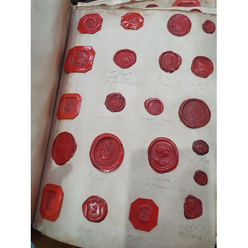 873 - A leather bound Book of historical seals, and a list of the names of the families