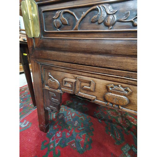 502 - A Chinese hardwood Cabinet on stand, the pair of cupboard doors carved vases and flowering branches,... 