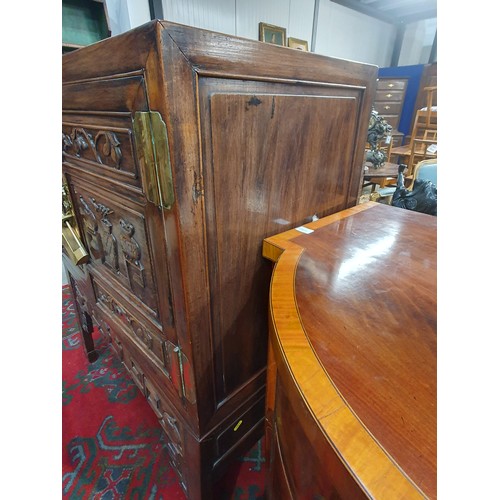 502 - A Chinese hardwood Cabinet on stand, the pair of cupboard doors carved vases and flowering branches,... 