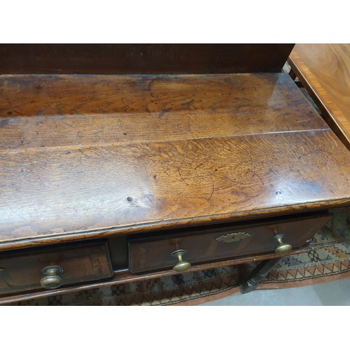 528 - An 18th Century oak Dresser Base with raised back, fitted four crossbanded frieze drawers on turned ... 