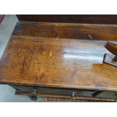 528 - An 18th Century oak Dresser Base with raised back, fitted four crossbanded frieze drawers on turned ... 