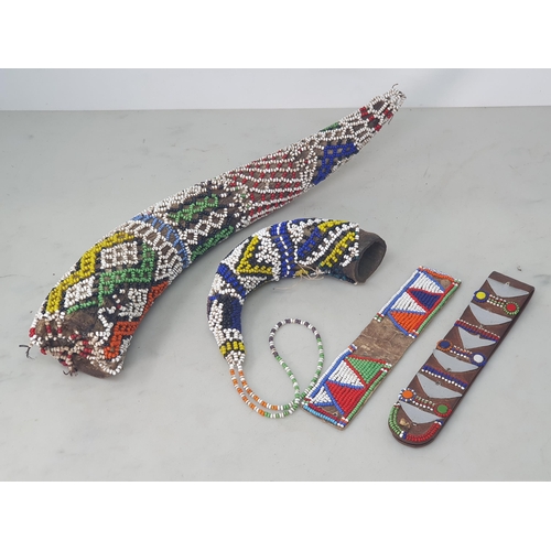 505 - Two Zulu or Ndebele beadwork covered Horns, a Masai beadwork Ear Ornament and another Masai leather ... 